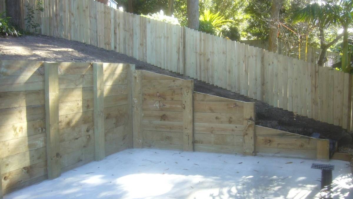 Terraced treated pine timber sleeper retaining wall stepping down a sloping Sydney yard